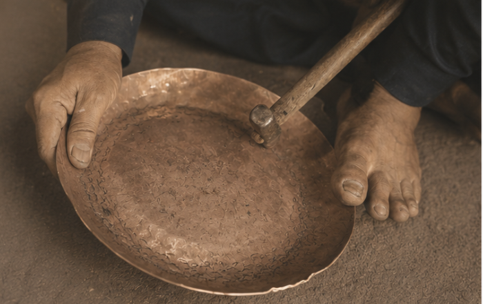 Hands engraving handcrafted vessel